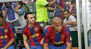 Iniesta and Henry wait patiently from the bench