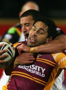Huddersfield Giants Rod Jensen tackled by a Bradford Bull
