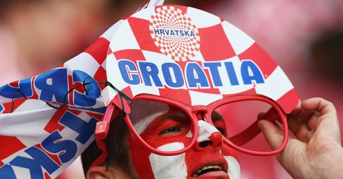 A Croatian supporter ensures that he has the best possible view of the action.