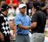 Tiger Woods and Phil Mickelson shake hands on the first tee.