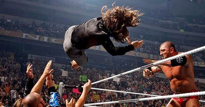 Batista launches SmackDown GM Vickie Guerrero over the top rope and into �The Family�.