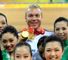 Chris Hoy shows off his triple gold triumph.