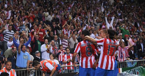 Atletico Madrid players run onto the sidelines in celebration at the Vicente Calderon stadium