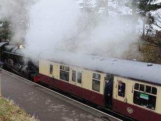Racegoers arrive by steam train.