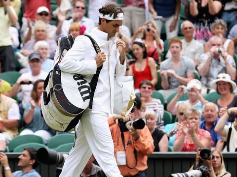 Roger Federer strides out on Centre Court ahead of his semi-final with Tommy Haas.