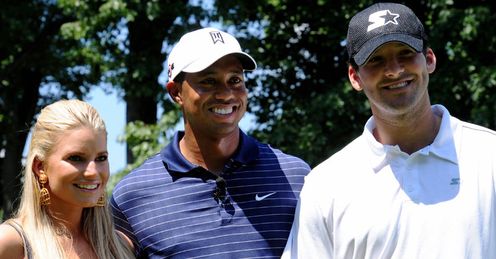 Tiger poses with Jess and Tony Romo.