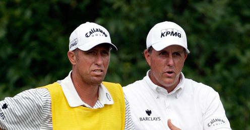 Phil Mickelson discusses a shot with Bones McKay.