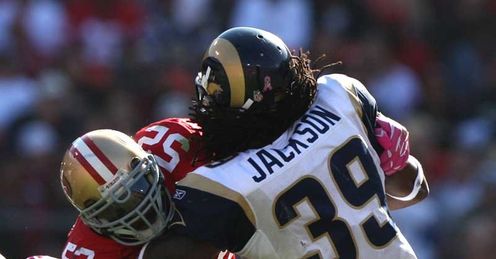 Hard-hitting: St Louis' Steven Jackson is crunched by the 49ers