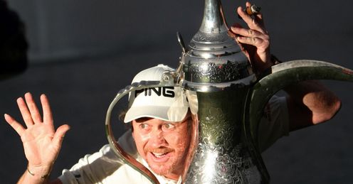 Miguel Angel Jimenez larks about with the huge Dubai trophy.