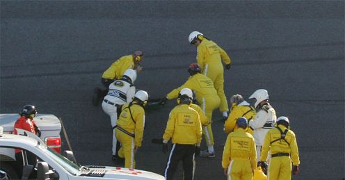 Running repairs: workers frantically fill a hole in the ageing Daytona tarmac