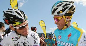 Cadel Evans and Alberto Contador share a word before the start of stage one.
