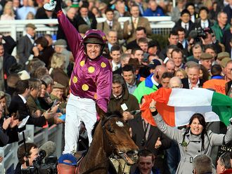 Jockey Barry Geraghty and Big Zeb's fans celebrate a Champion Chase triumph.