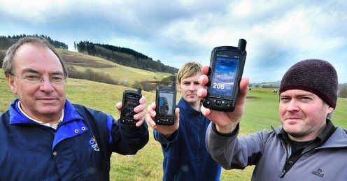 Matt Cooper (far right) and the new SkyCaddie SGX.