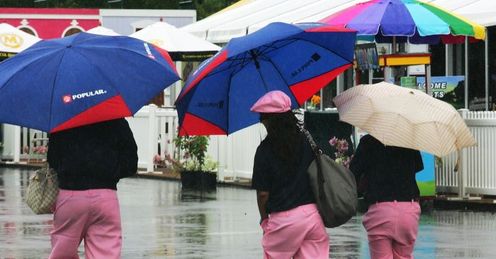 Volunteers head for shelter after the first round was suspended