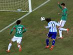 Carlos Tevez heads in Argentina's controversial opener...