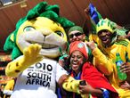 The World Cup mascot Zakumi poses with some football fans inside the Soccer City Stadium as the Opening Ceremony gets under way.