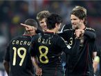 Germany rush to celebrate with goalscorer Mesut Ozil at the final whistle.