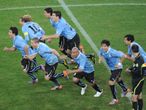 Uruguay race to celebrate their shoot-out victory.