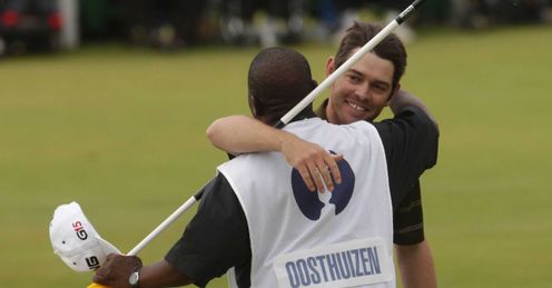 A jubilant Louis Oosthuizen hugs his caddy after his seven-stroke victory