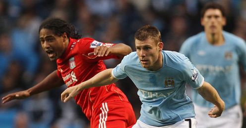 James Milner and Glen Johnson tussle for the ball during Man Citys game with Liverpool