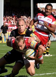 Tim Taylor of Gloucester is tackled by Mark van Gisbergen Tim Taylor of Gloucester is tackled by Mark van Gisbergen