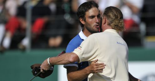 Jimenez can be seen with his new putter as he is congratulated by Edoardo Molinari at Crans-sur-Sierre
