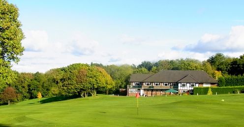 The 18th green at Wrekin Golf Club, Shropshire, with the clubhouse in the distance.