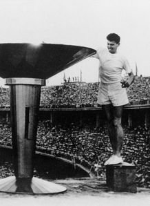 Ron Clarke lights the Olympic Flame in Melbourne.