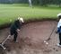 Caroline practices a bunker shot with Manuel De Los Santos