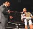 WWE's Chief Operating Officer, Triple H, talks to CM Punk in the ring