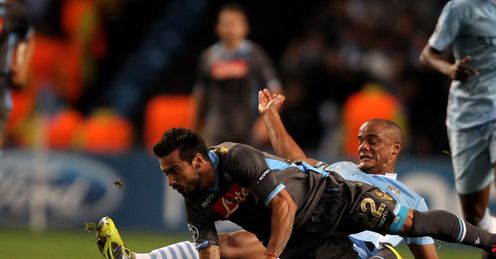 Slide and tested: Kompany gets stuck into Ezequiel Lavezzi at the Etihad Stadium