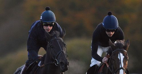 Harry Skelton, on Big Bucks, and Ruby Walsh, on Kauto Star, gallop after racing at Exeter