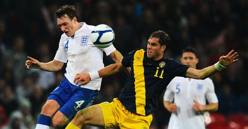 Up to the challenge: Jones keeps a close eye on Sweden's Johan Elmander at Wembley
