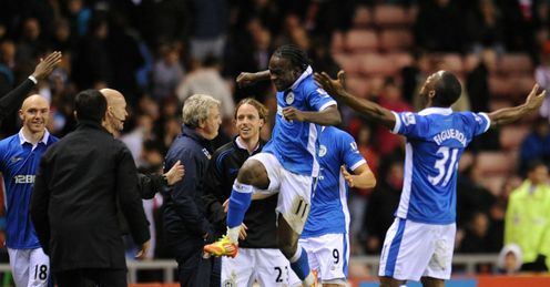 Final blow: Bruce cuts a forlorn figure as Wigan celebrate Franco di Santo's winner
