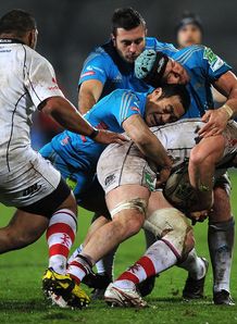 Stephen Ferris of Ulster is stopped by Sinoti Sinoti and Carlo Del Fava of Aironi