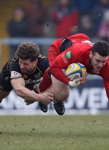 Duncan Taylor of Saracens is tackled by Dominic Waldouck of Wasps