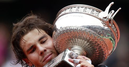 Close inspection: Nadal examines his silverware after surviving Djokovic's scrutiny