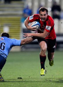 Israel Dagg of the Crusaders breaks past the tackle of Willie Wepener L of the Bulls