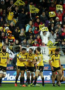 Julian Savea of the Hurricanes is congratulated on his try by teammates