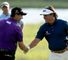 Padraig Harrington (L) and Phil Mickelson shake hands as the prepare to start their second rounds.