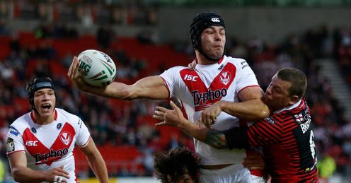 Mark Flanagan C of St Helens passes the ball in the tackle of Stefan Ratchford L and Lee Briers of Warrington Mark Flanagan C of St Helens passes the ball in the tackle of Stefan Ratchford L and Lee Briers of Warrington