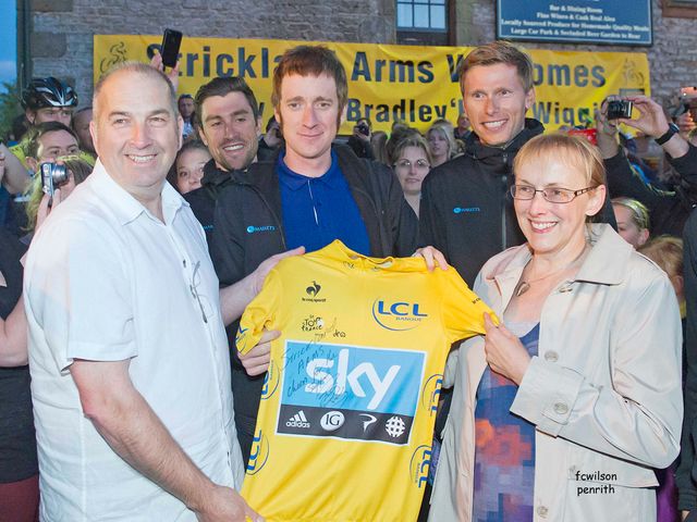 Bradley Wiggins presents a signed yellow jersey