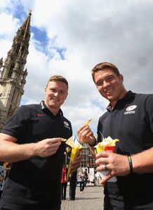Chris Ashton L and John Smit of Saracens eat a bag of Belgian frites
