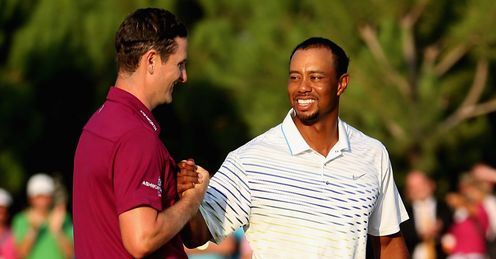 Tiger (R) congratulates Rose on his victory