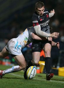 Nick Scott of London Welsh is tackled by Alex Grove