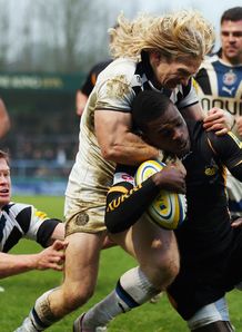 Christian Wade of London Wasps is tackled by Tom Biggs of Bath