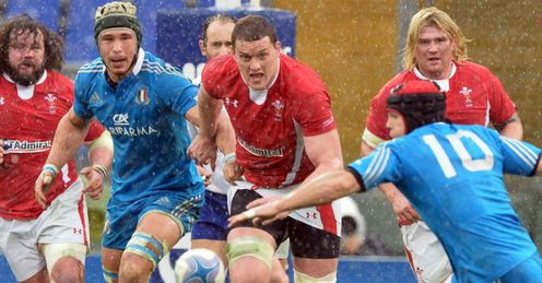 Ian Evans C of Wales runs with Italians Kris Burton R Ian Evans C of Wales runs with Italians Kris Burton R