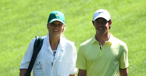 Wozniacki (L) caddying for McIlroy at last year's par three Masters event