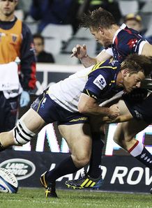 Brumbies wing Clyde Rathbone making a tackle Brumbies wing Clyde Rathbone making a tackle