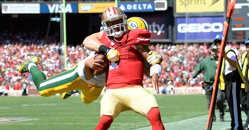 Clay Matthews of the Green Bay Packers tackles Colin Kaepernick of the San Francisco 49ers